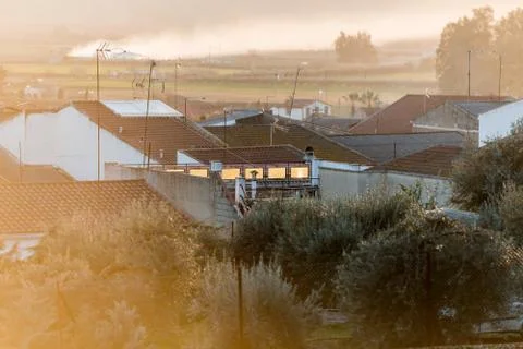 The light of the sunset reflected in the windows and on the roofs of Medellin Stock Photos
