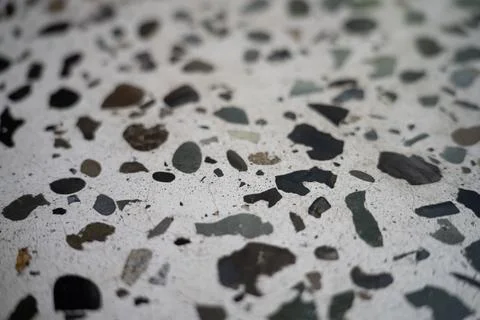 Light surface with rocks sprinkled throughout the texture Stock Photos