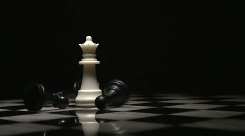 Light Sweep Over White Queen and Fallen Black Pawns Stock Footage 61405786