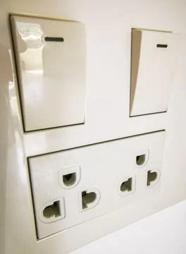 Light Switch And Electrical Outlets On Wall In Thai Hotel Room Thailand. Stock Photos