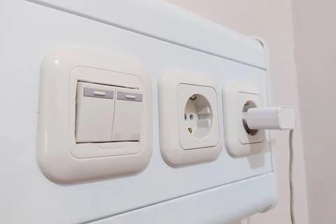 Light switch and power outlet Stock Photos