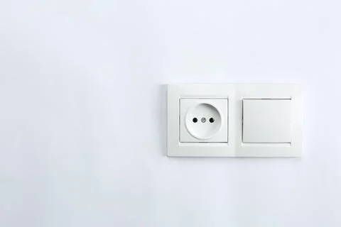 Light switch and power socket on white background. Electrician's equipment Stock Photos