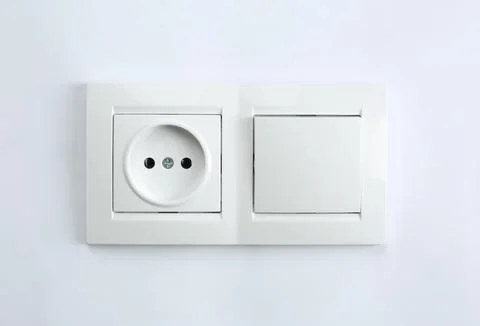 Light switch and power socket on white background. Electrician's equipment Stock Photos