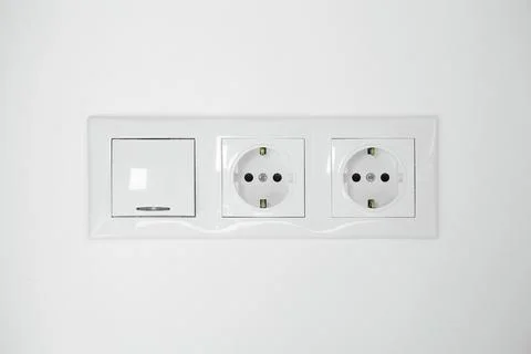 Light switch and power sockets on white wall indoors Fotos Stock