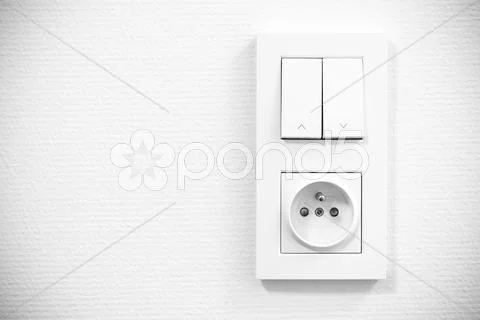 Light Switch And Socket In Frame On The Wall