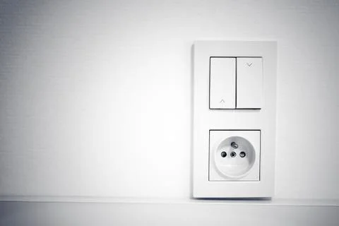 Light switch and socket in frame on the wall Stock Photos