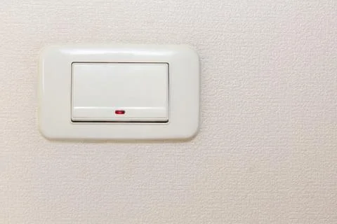 Light switch on beige wall. Stock Photos