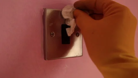 Light switch being wiped down in domestic house Stock Footage 142387571