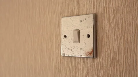 Light switch being wiped down in domestic house Stock Footage 142389750