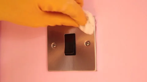 Light switch being wiped down in domestic house Stock Footage 142390348