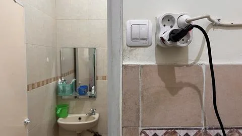 Light switch button, Power plug and socket stuck to the wall. Stock Photos