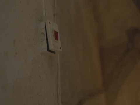 A light switch in a dark stairwell. LOG Stock Footage 83782024