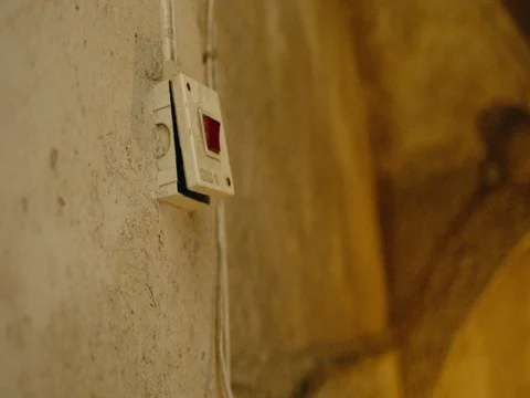 A light switch in a dark stairwell. REC709 Stock Footage 83783201
