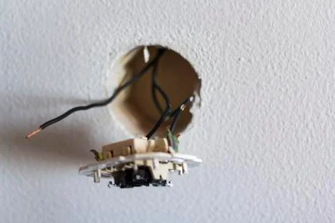 Light switch disassembled with exposed wires Stock Photos
