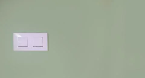 Light switch on a green wall Stock Photos