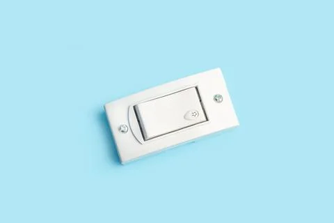 Light switch on a light blue background with copy space Foto stock