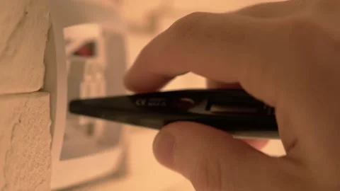 Light switch repair process. checking the network voltage with a tester. Stock Footage 217343594