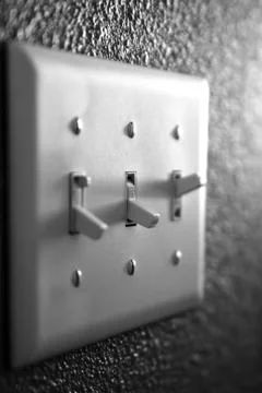 Light switch on wall inside a home Stock Photos