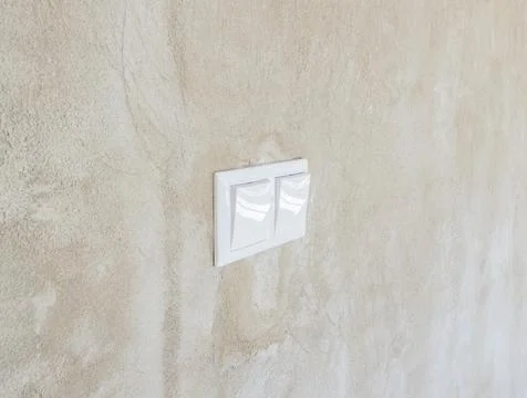 Light switch on the wall in the loft style in the apartment or office Stock Photos