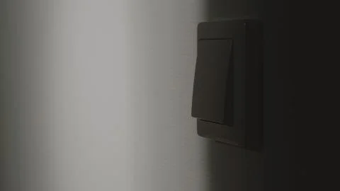 Light switch on the wall in the night Stock Photos