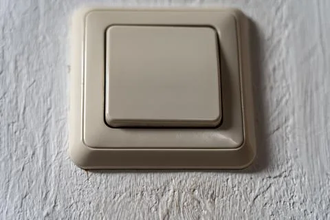 Light switch on the white wall to turn on the light Stockfoto's