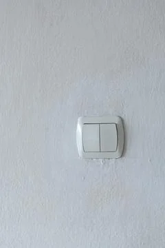 Light switch on a worn textured wall Stock Photos