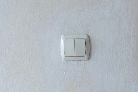Light switch on a worn textured wall Stock Photos