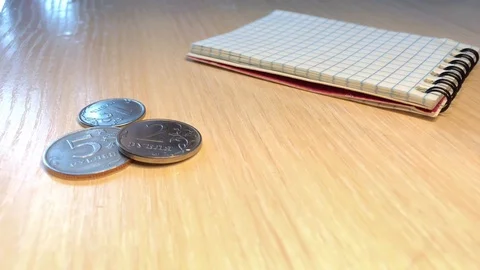 Light table and a few coins near the notebook Stock Footage 123689066