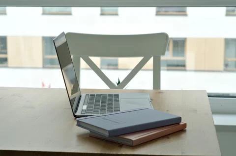 Light table with chairs with laptop. workspace on kitchen table. notepads Foto stock