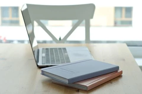 Light table with chairs with laptop. workspace on kitchen table. notepads Foto stock