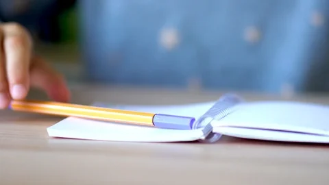 On a light table lies an open notebook on a spring. Yellow pen on a notebook Stock Footage 126059077