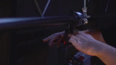 Light technician attaches the spotlight screw to the base of the stage to Stock Footage 102482242