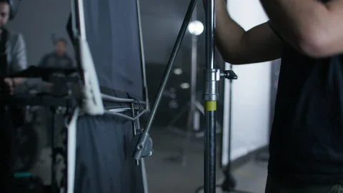 Light technician sets up equipment, preparing movie recording 스톡 동영상 198271655