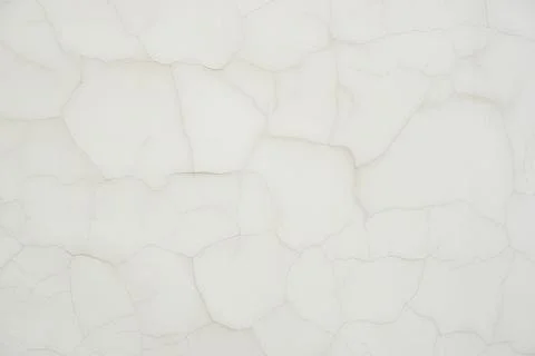 Light texture of thin neat cracks on the wall, similar to wallpaper. Stock Photos