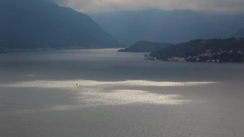 Light through the clouds on shimmering Lake Como, Italy Vidéo 260481846
