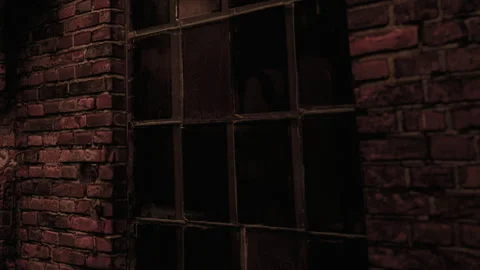 Light through the window of an old brick building at night Stock Footage 341801944