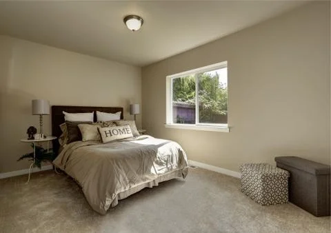 Light tones bedroom interior with large bed. Northwest, USA Stock Photos
