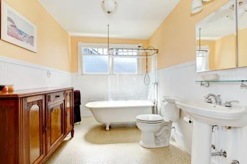 Light tones small bathroom with a whiskey color antique cabinet. Northwest, U Stock Photos