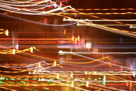 Light traces background. Lights trails dynamic backdrop. Night exposure motio Stock Photos