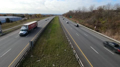 Light traffic on divided highway under cloudy sky. Stock Footage 143933752