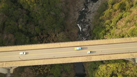 Light Traffic Over Bridge Spanning Canyon in Japan 動画素材 210028953