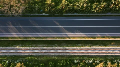 Light traffic on a road that runs parallel to a train railway Stock-Footage 172523995