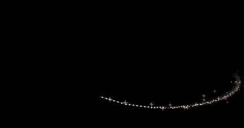 A light trail of shimmering particles gracefully wraps around the invisible Stock-Footage 325083502