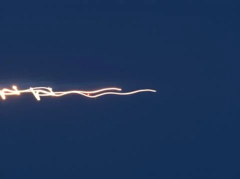Light trail streak with motion blur against a dark blue sky Stock Photos