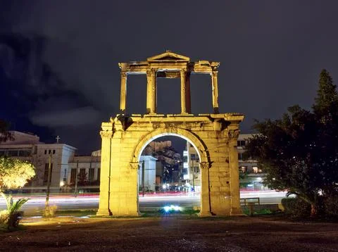 Light trails behind Hadrian Arch at night, Athens, Greece Stock Photos