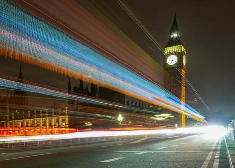 Light trails from passing buses on Westminster Bridge with Big Ben at night Stock Photos