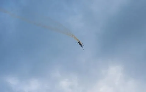Light training plane doing figures in dark skies Stock Photos
