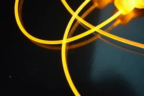 Light transparent wire, cable, polyethylene tubes, rods of yellow lines. Stock Photos