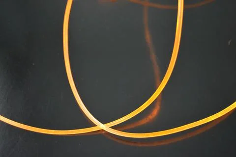 Light transparent wire, cable, polyethylene tubes, rods of yellow lines. Stock Photos