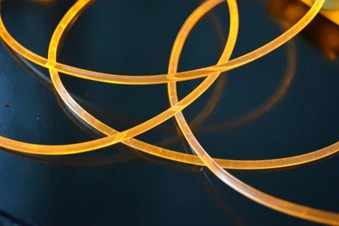 Light transparent wire, cable, polyethylene tubes, rods of yellow lines. Stock Photos